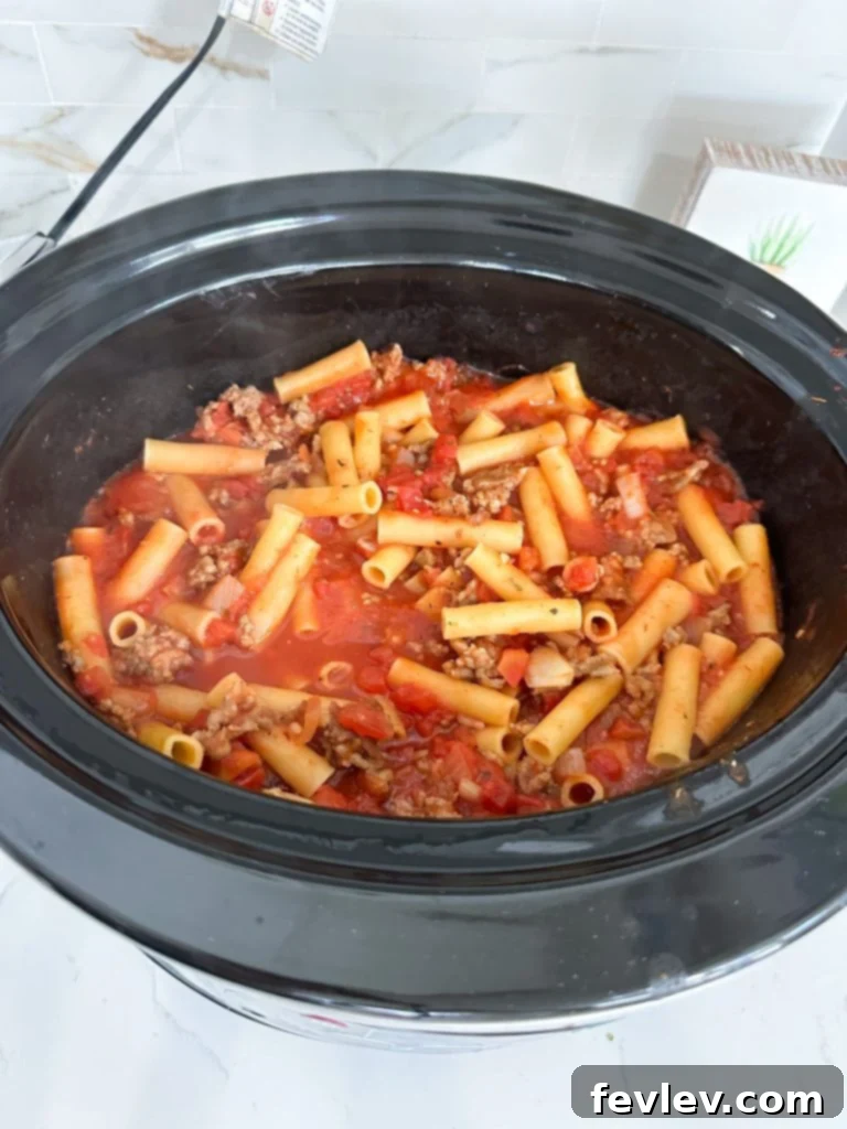 cooked slow cooker baked ziti with melted cheese