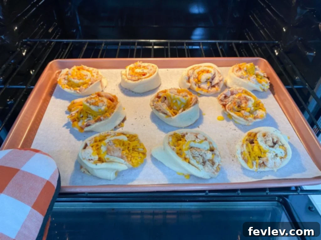 Smoky BBQ Chicken Pinwheels 3 Close-up of BBQ Chicken Roll Ups on a baking sheet, golden and bubbly