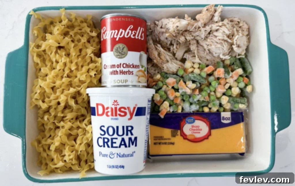 Creamy Chicken Noodle Casserole baked to golden perfection, topped with melted cheddar cheese, served in a rustic baking dish.