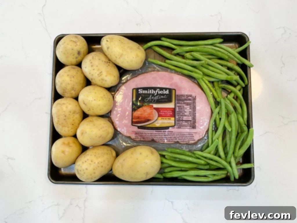 Golden Honey Mustard Ham with Roasted Green Beans and Potatoes 2 A vibrant sheet pan meal featuring roasted honey mustard ham, tender green beans, and golden potatoes, perfectly cooked and ready to serve.