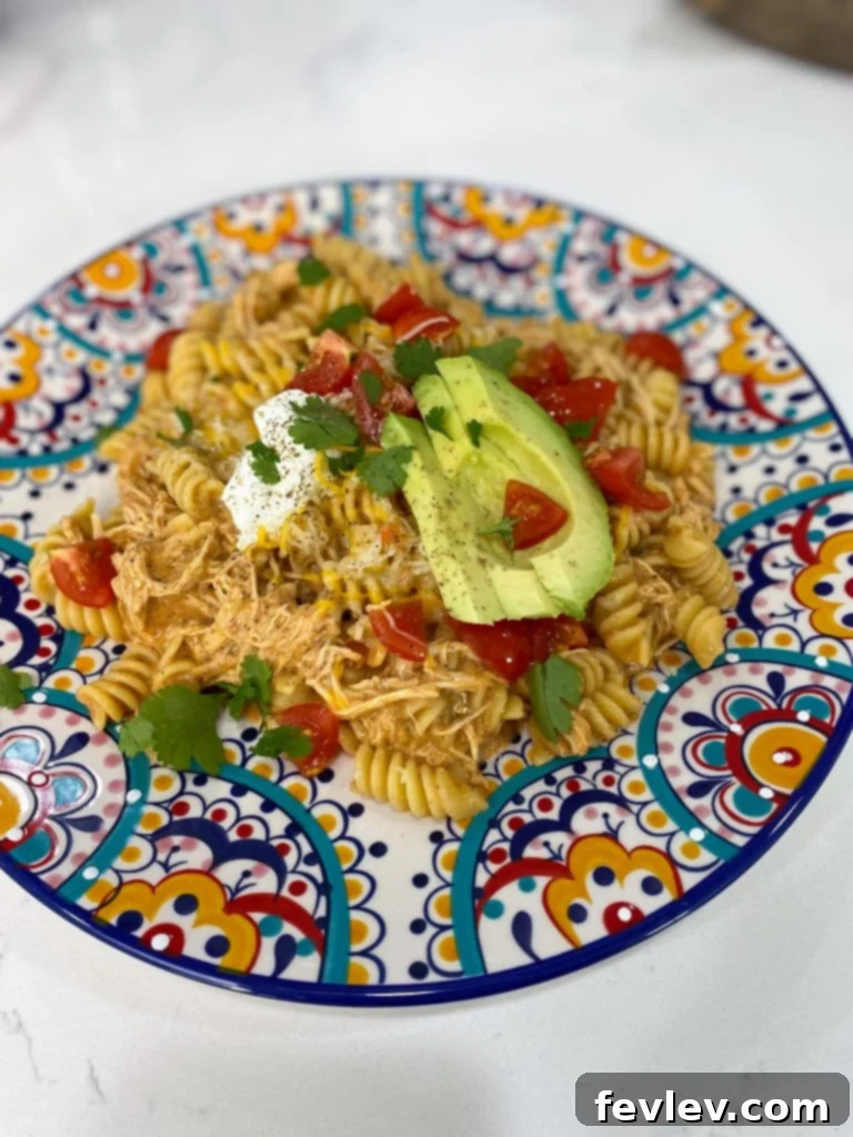 Ingredients for Slow Cooker Chicken Enchilada Pasta laid out on a kitchen counter.