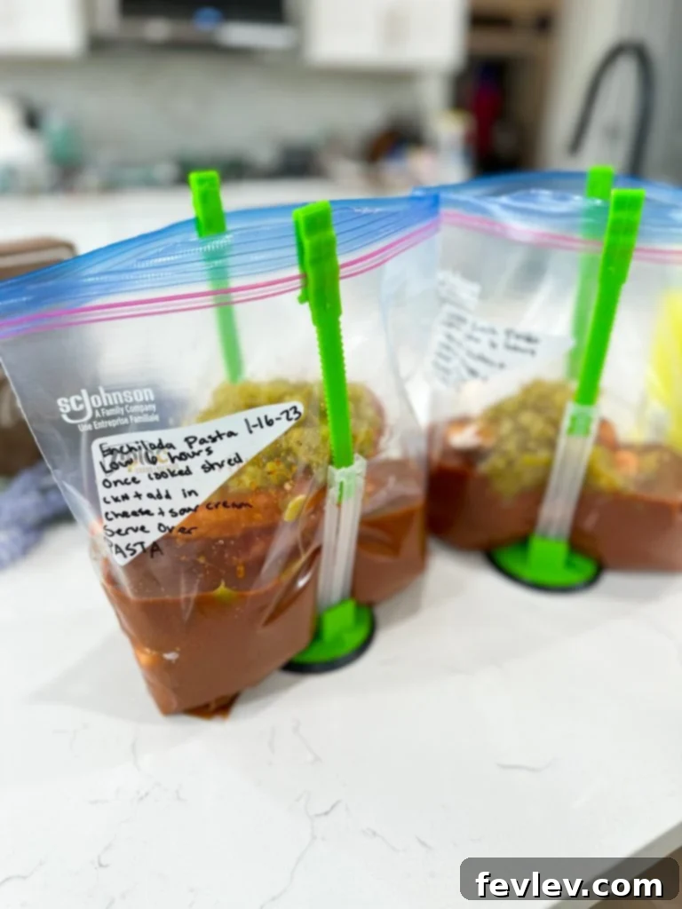 Freezer bag filled with ingredients for Slow Cooker Chicken Enchilada Pasta, ready for freezing.