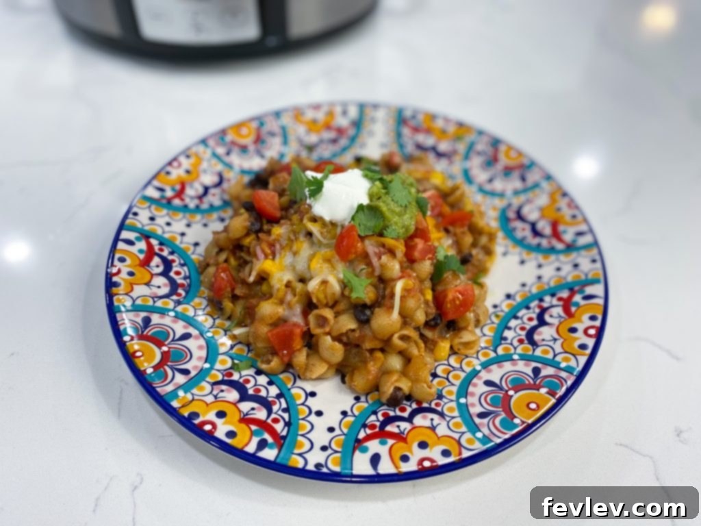 Slow Cooker Fiesta Pasta 3 Overhead shot of Slow Cooker Mexican Pasta cooking, showing the vibrant mixture of pasta, beans, corn, and cheese