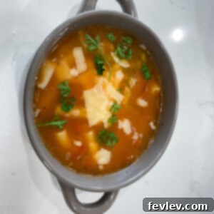 Delicious Vegetable Noodle Soup ready to be served, garnished with fresh herbs.
