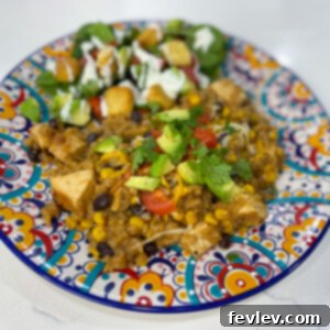A close-up of a completed serving of Cowboy BBQ Chicken and Rice, garnished with fresh toppings.