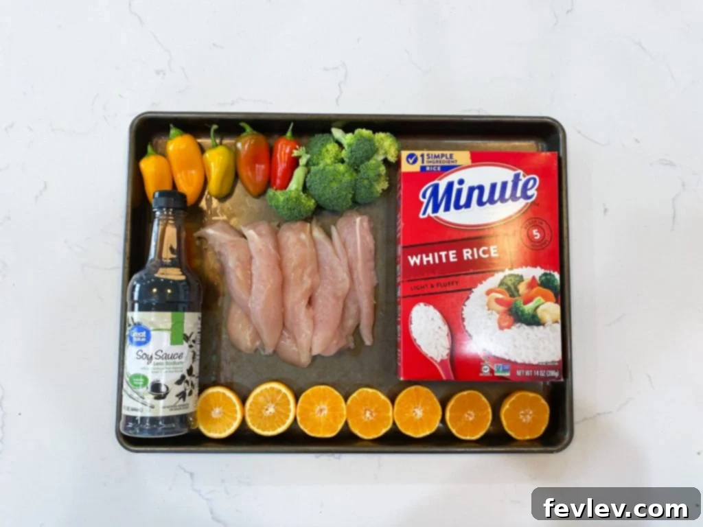 Radiant Orange Chicken 2 Healthy orange chicken on a sheet pan with broccoli and bell peppers, baked to perfection.