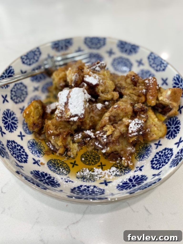 Effortless Cinnamon Pecan Slow Cooker French Toast Bake 4 Close-up of cooked Slow Cooker French Toast Casserole, showing the crumbly pecan and cinnamon topping.