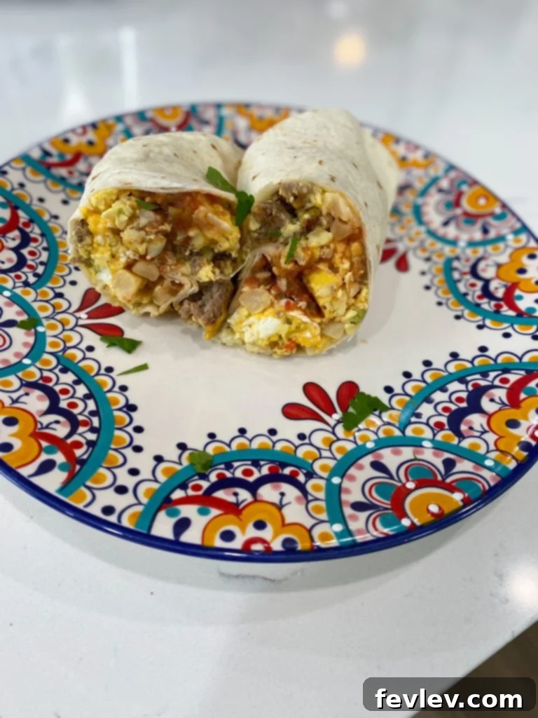 Close-up of the slow cooker filled with layered ingredients for breakfast burritos: thawed potatoes, cooked sausage, a generous layer of shredded cheese, and golden whisked eggs on top.