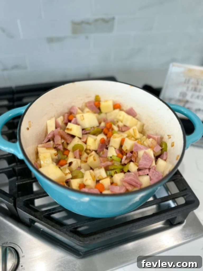 Close-up of fresh, diced vegetables including onions, celery, and carrots, ready for the Ham and Potato Soup.