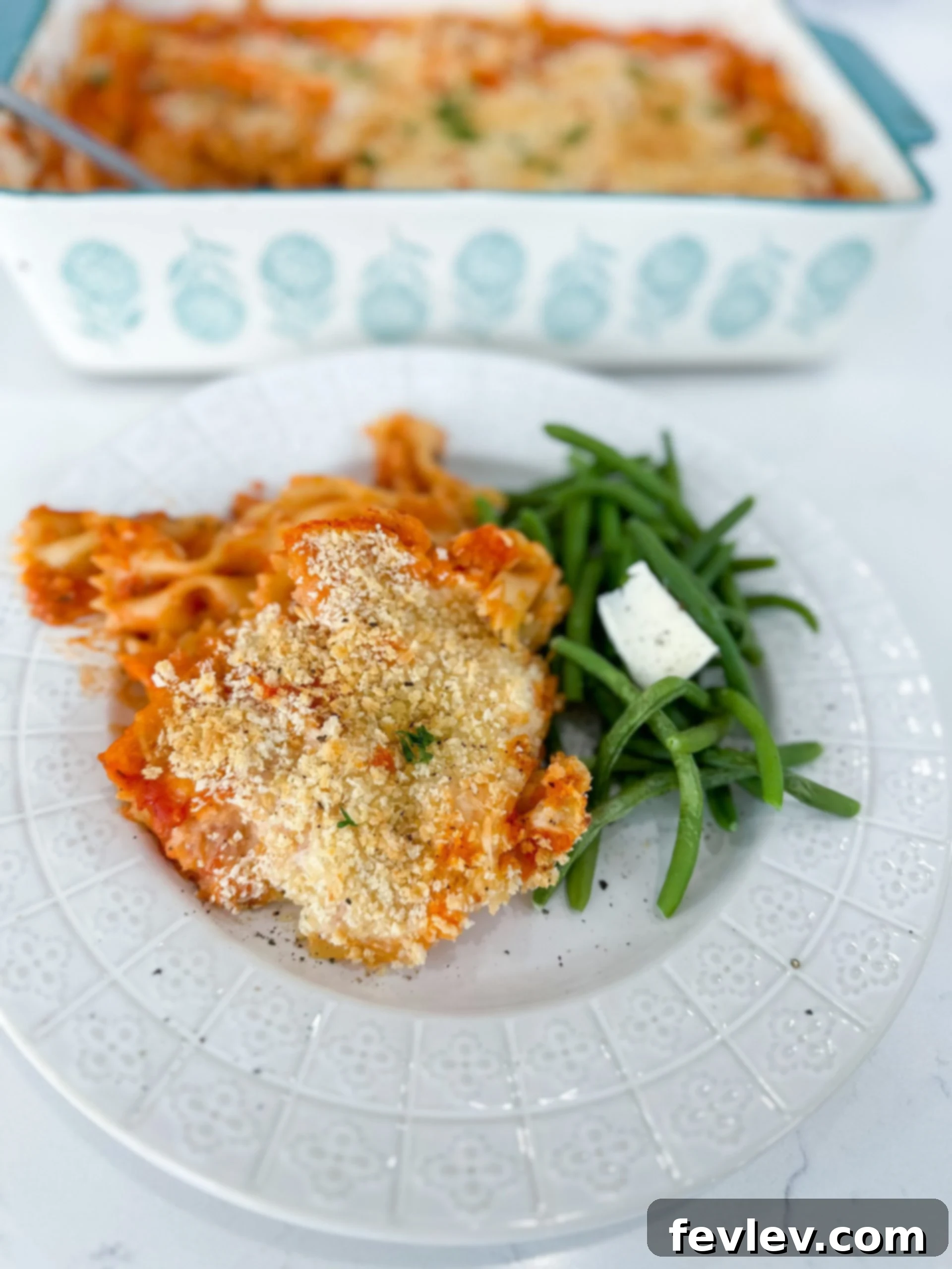 Baked chicken parmesan casserole topped with melted cheese and golden breadcrumbs, ready to serve