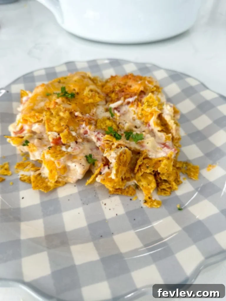 Close-up of the ingredients for Dorito Chicken Casserole, showcasing the Cool Ranch Doritos, shredded chicken, and cheese.