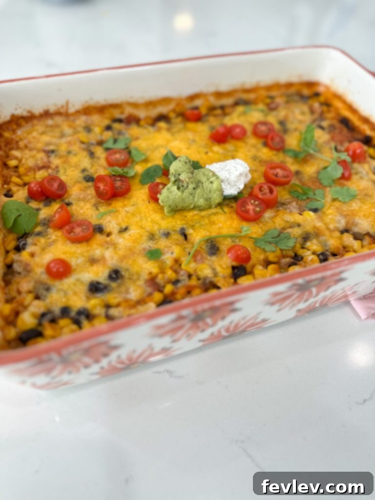 Zesty Fiesta Veggie Bake 3 Close-up of the vegetarian Mexican casserole ingredients being mixed in a baking dish before cooking.