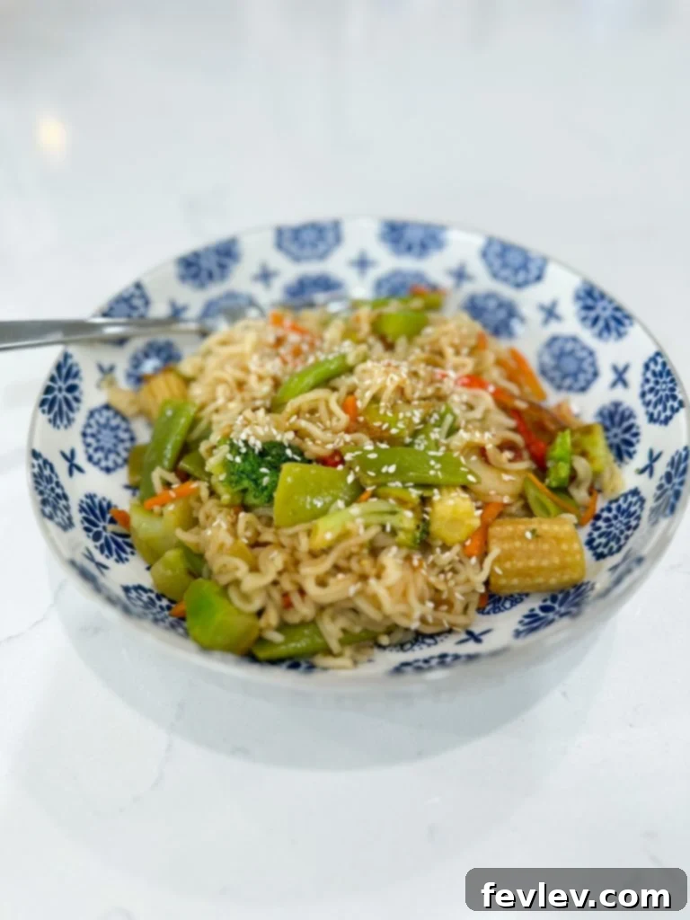 Sizzling Veggie Ramen Stir Fry 3 Key ingredients for Ramen Noodle Stir Fry laid out on a counter, including a bag of frozen vegetables, ramen packets, olive oil, and soy sauce.