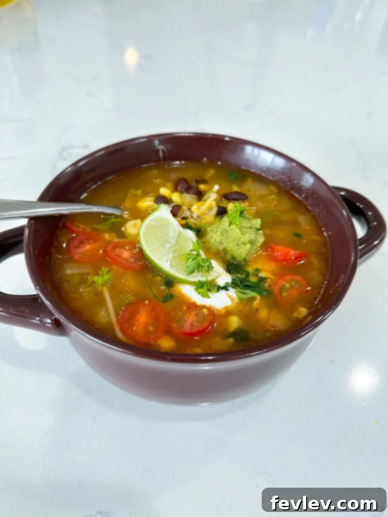 Close-up of fresh and canned ingredients for Spanish Rice Soup laid out on a kitchen surface.