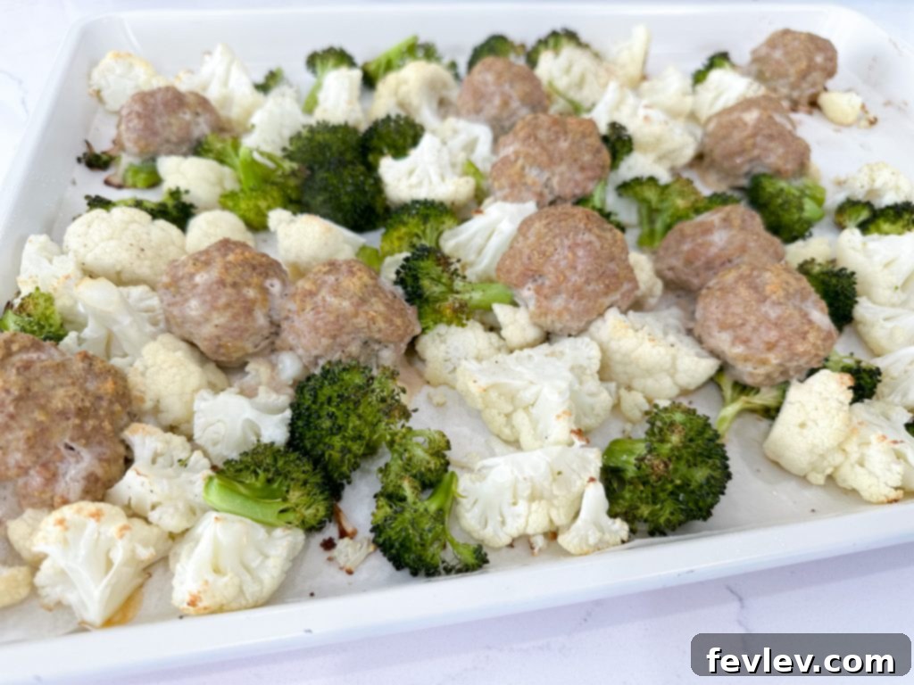Close-up of fresh ingredients for turkey meatball subs, including ground turkey, broccoli, cauliflower, hoagie rolls, and spices.