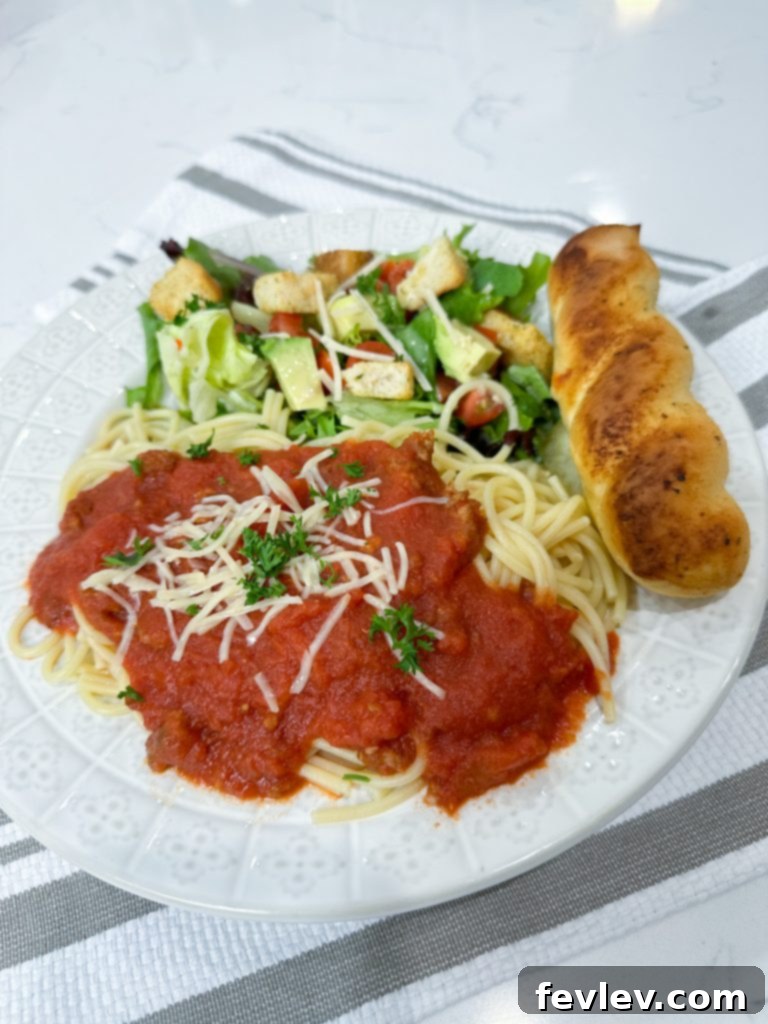 Close-up of a serving of slow cooker spaghetti sauce with fresh basil, ready for dinner.