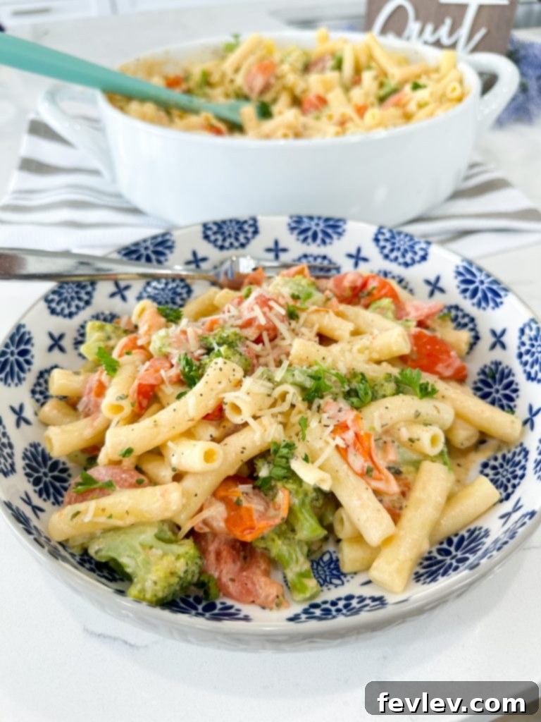 Finished Boursin Cheese Pasta with a generous serving of creamy sauce, tomatoes, and broccoli