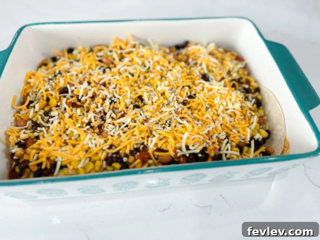Prepared ingredients for black bean enchilada casserole in bowls