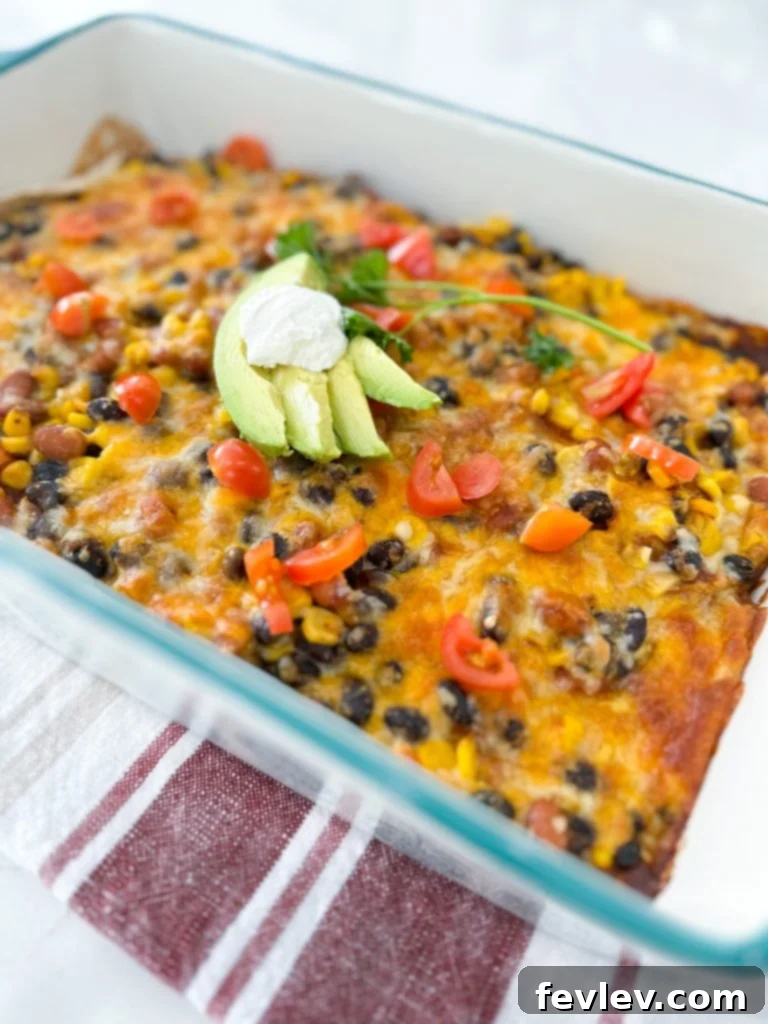 Close-up of a slice of Black Bean Enchilada Casserole, showing the layers