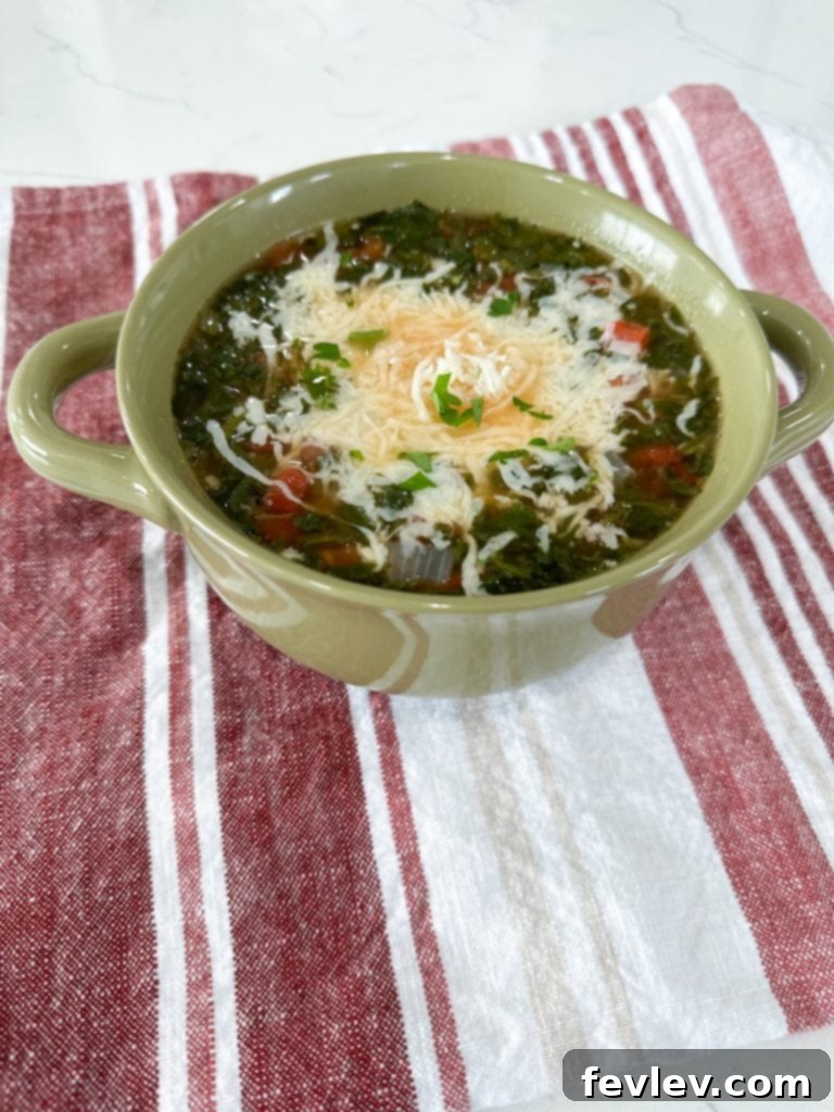 A pot of White Bean and Spinach Soup simmering on the stove, steam rising.