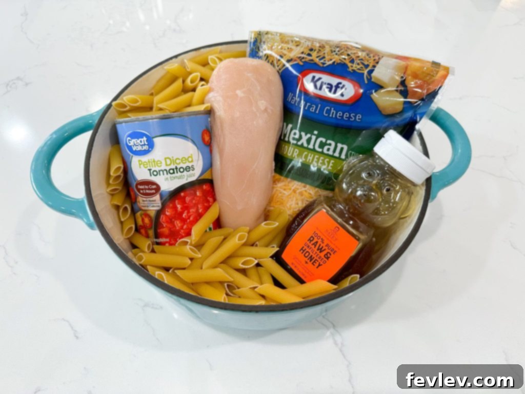 Delicious Tomato Honey Pasta with Chicken in a large pot, garnished with fresh herbs.