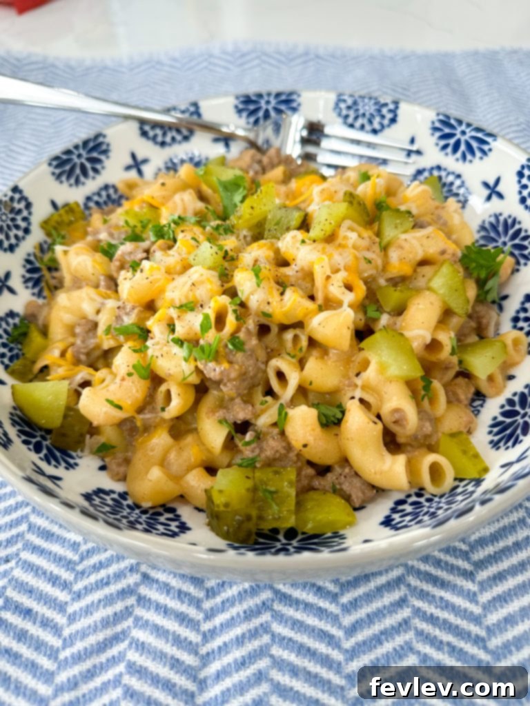 Homestyle Cheeseburger Pasta 4 Close-up of a serving of Cheeseburger Pasta topped with chopped pickles