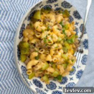 Homestyle Cheeseburger Pasta 5 A top-down view of a bowl of Cheeseburger Pasta with fresh parsley and a fork