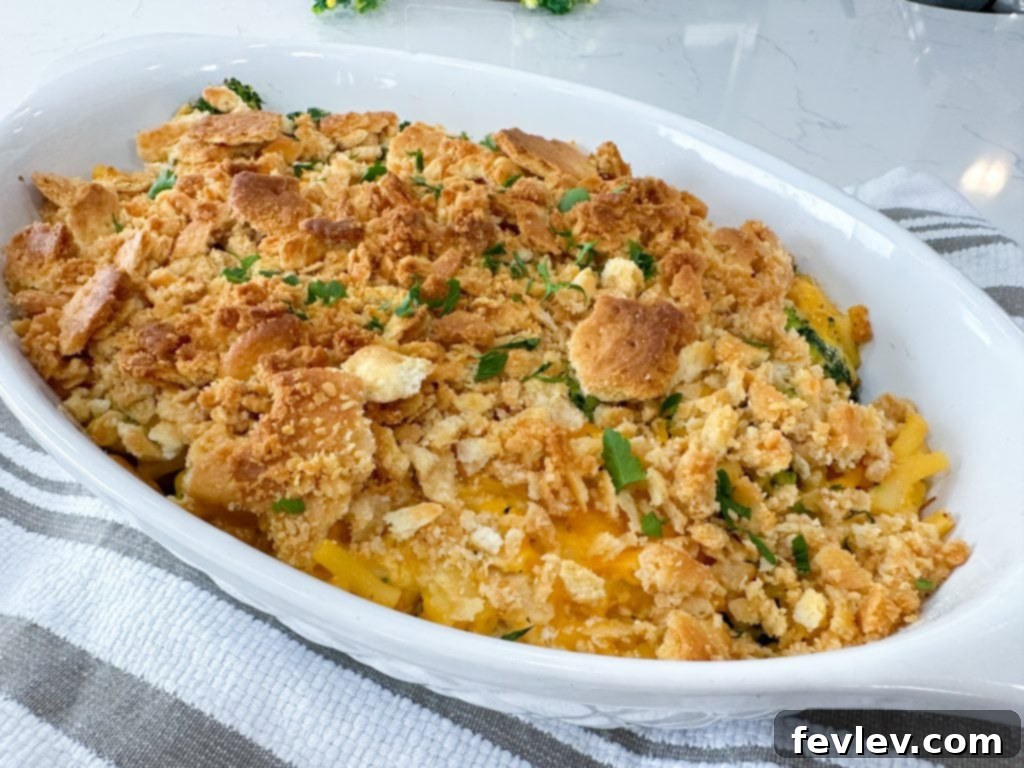 A serving of Chicken and Broccoli Macaroni Cheesy Casserole scooped onto a plate, showing the creamy texture.