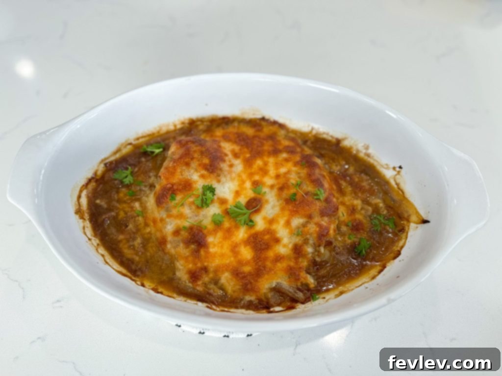 A serving of French Onion Chicken Casserole with melted cheese, perfect for a cozy meal.