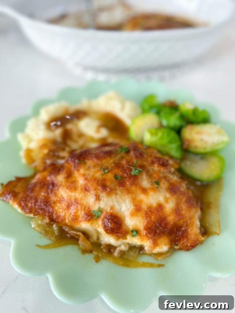 A side shot of French Onion Chicken Casserole, showcasing the layers of chicken, onions, and cheese.