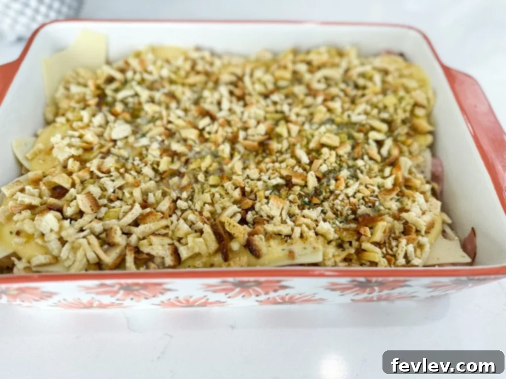 Layering ingredients for Chicken Cordon Bleu Casserole
