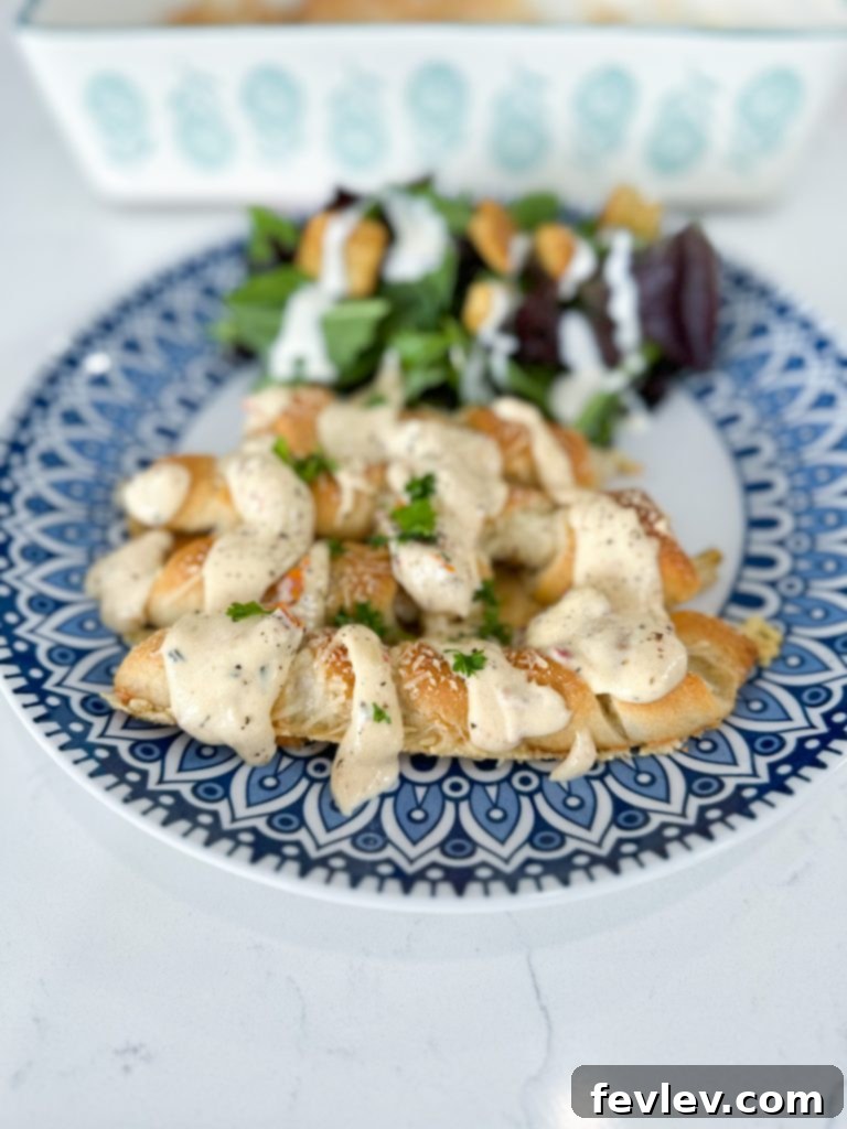 Golden Crescent Chicken with Sun-Dried Tomato Cream 2 Golden baked chicken wrapped in crescent dough, drizzled with creamy sun-dried tomato sauce