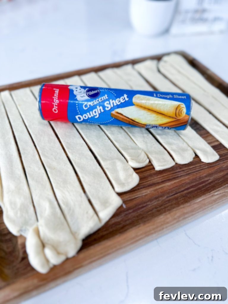 Golden Crescent Chicken with Sun-Dried Tomato Cream 6 Unrolled crescent dough sheet and cut into strips on a cutting board.