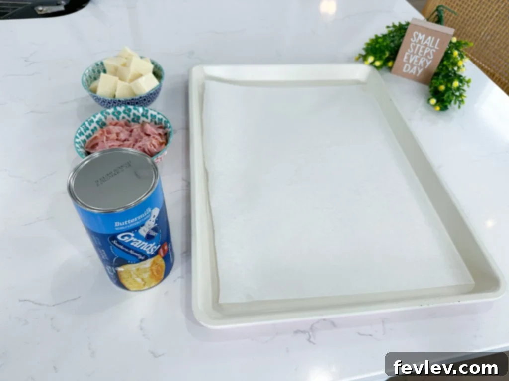 Golden brown Stuffed Ham and Cheese Biscuits on a baking sheet, ready to serve.