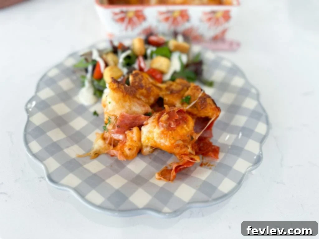 Ultimate Italian Sub Bake 6 A freshly baked Italian Sub Casserole, golden brown and bubbling with melted cheese, removed from the oven and ready to be served, showcasing its delicious appeal.