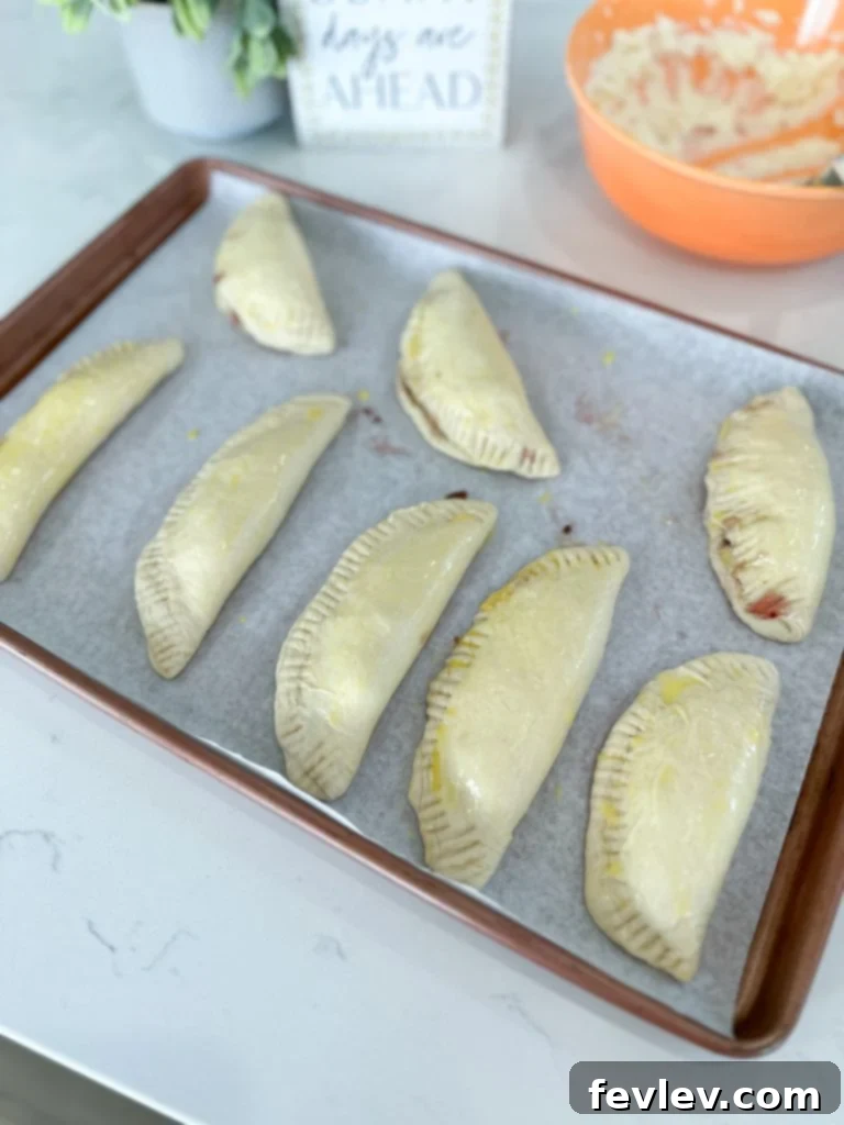 Filling and sealing the Berry Cheesecake Hand Pies before baking.
