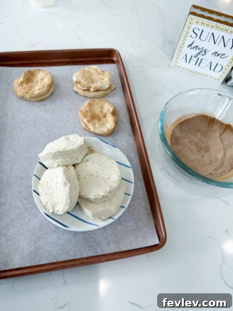 Cinnamon Swirl Biscuits 2 Delicious Cinnamon Roll Biscuits, golden brown and drizzled with sweet icing, ready for breakfast or dessert. A perfect quick treat.