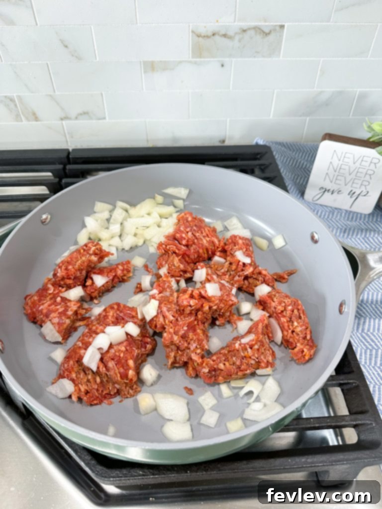 The Ultimate Slow Cooker Sausage Tortellini Bake 3 Browning Italian sausage and onions for slow cooker tortellini lasagna