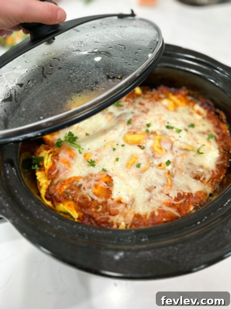 The Ultimate Slow Cooker Sausage Tortellini Bake 7 Tortellini lasagna topped with mozzarella cheese before cooking in the slow cooker