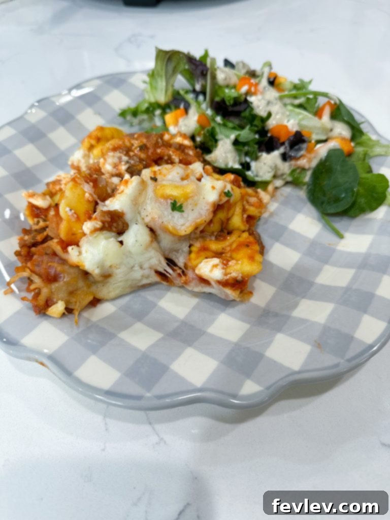 The Ultimate Slow Cooker Sausage Tortellini Bake 8 Serving of cooked slow cooker tortellini lasagna with melted cheese