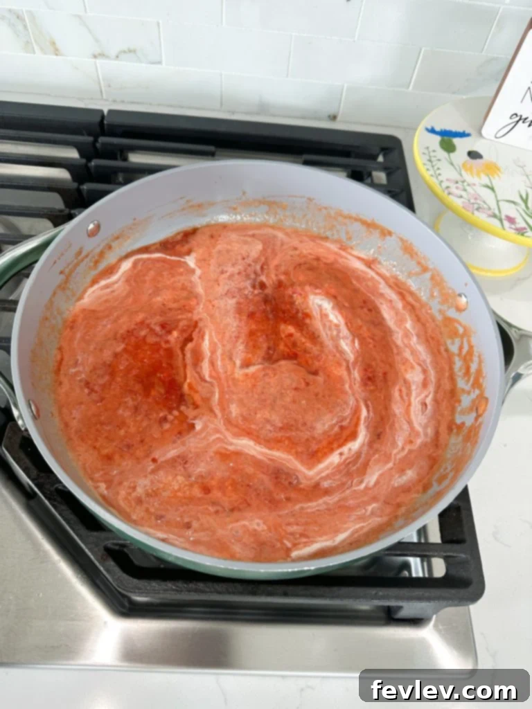 Cooking garlic in a skillet for tortellini