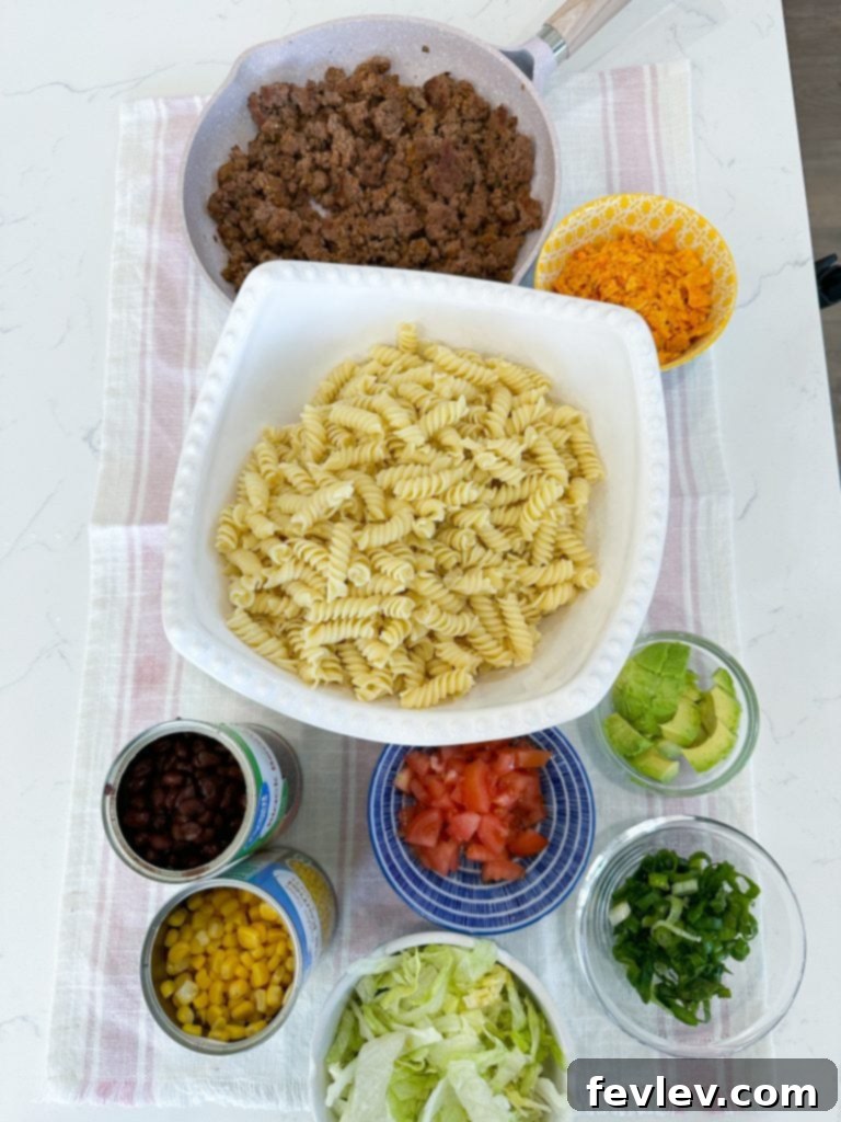 Nacho Taco Pasta Crunch 2 Delicious Doritos Taco Pasta Salad in a large serving bowl, garnished with fresh cilantro.