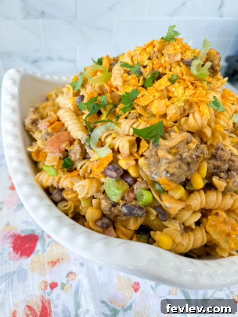 Nacho Taco Pasta Crunch 9 A generous serving of Doritos Taco Pasta Salad in a bowl, showing the crushed Doritos.