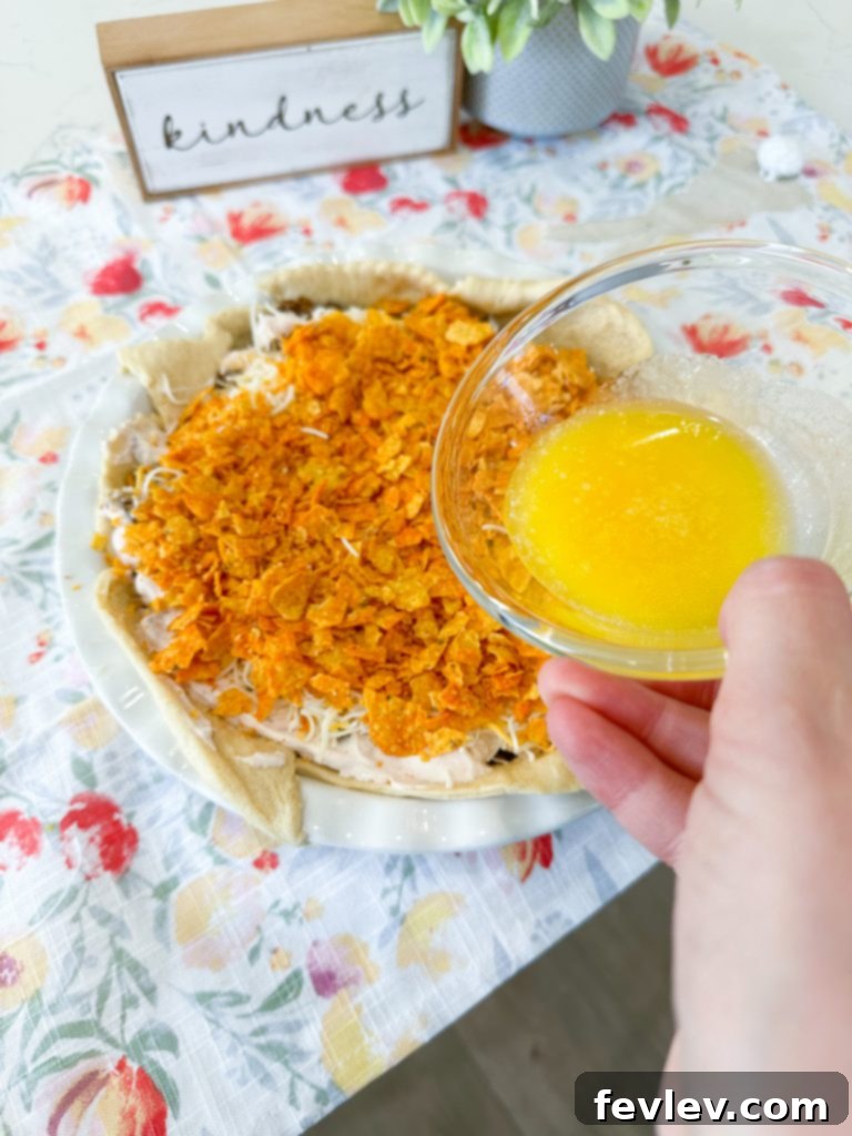 Melted butter drizzled over the top Dorito layer