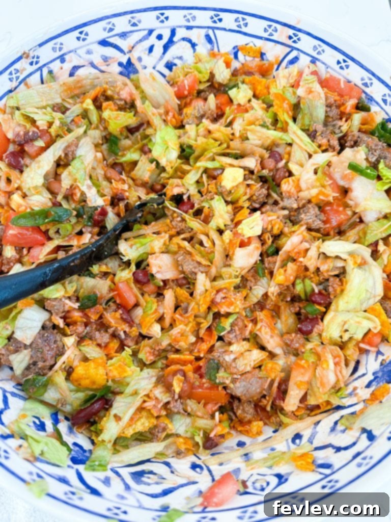 Catalina Doritos Taco Salad 6 A bowl of vibrant Catalina dressing, ready to be poured over the taco salad ingredients.