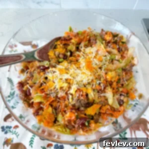 A beautifully presented bowl of Taco Salad with Catalina Dressing and Doritos, featuring a savory beef base and fresh toppings.