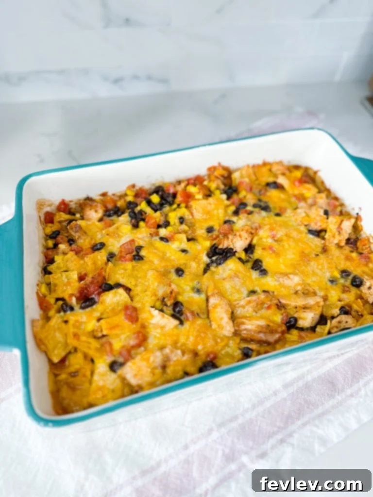 Cheesy Chicken Tortilla Bake 3 close-up of ingredients for chicken tortilla casserole including corn, beans, and shredded chicken