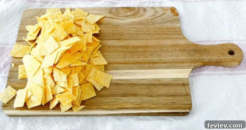 Cheesy Chicken Tortilla Bake 5 Step 2: Adding shredded chicken to a large mixing bowl