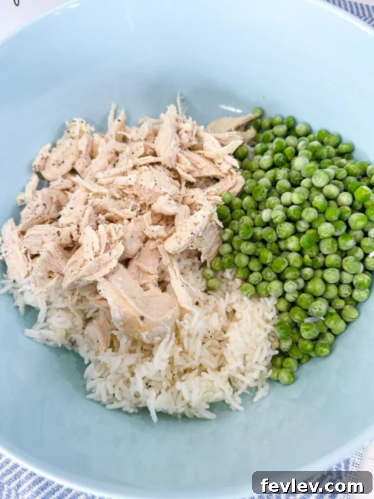 Cooked rice being added to a large mixing bowl