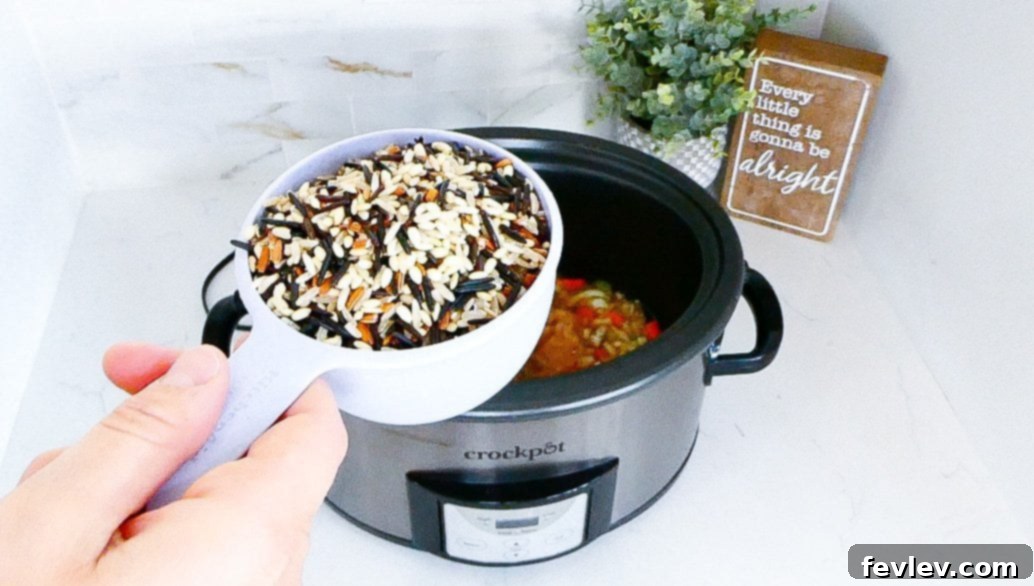 Savory Slow Cooker Chicken and Wild Rice with Veggies 6 Slow cooker chicken and wild rice after cooking, before adding cheese, showing the tender chicken and perfectly cooked rice.